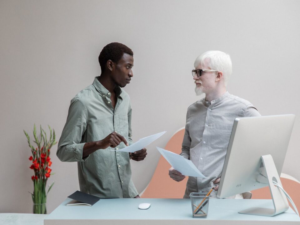 multiracial coworkers with papers in office