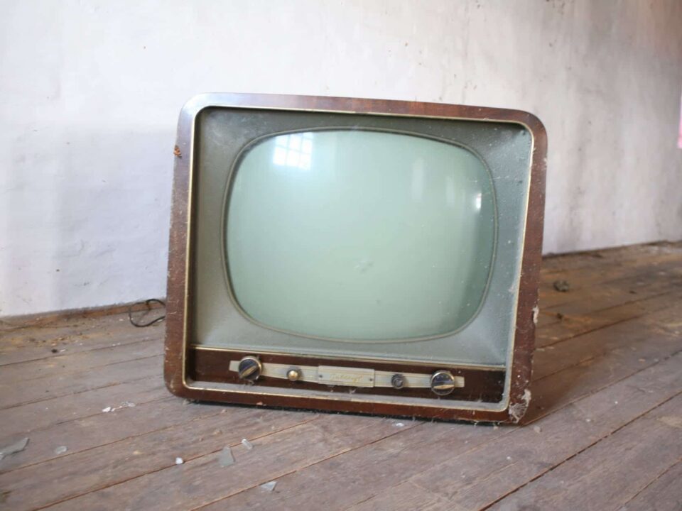 vintage brown crt tv on parquet wood flooring